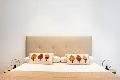 a bedroom with a bed with two pillows on it at BiS Suites Ruzafa in Valencia