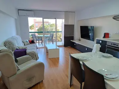 a kitchen and living room with a table and chairs at Fleming's Beach in Puebla de Farnals