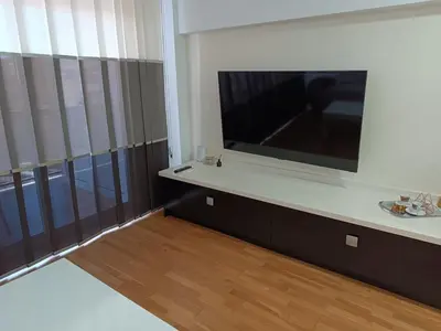 a living room with a large flat screen tv at Fleming's Beach in Puebla de Farnals