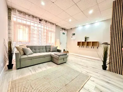 a living room with a couch and a rug at Estudio Benicalap in Valencia