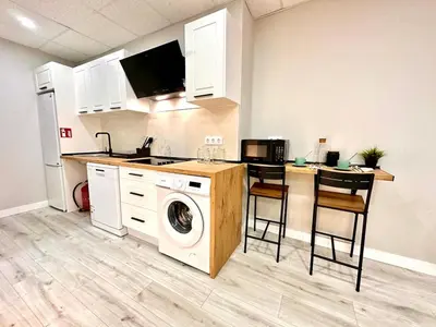 a kitchen with a washing machine and a counter at Estudio Benicalap in Valencia