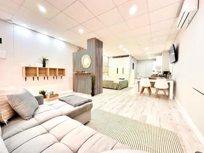 a living room with a couch and a table at Estudio Benicalap in Valencia