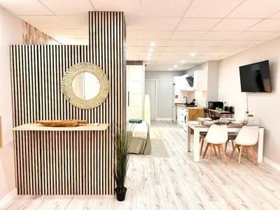 a kitchen and dining room with a table and chairs at Estudio Benicalap in Valencia