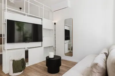 a living room with a couch and a flat screen tv at Gran Turia Apartments in Valencia