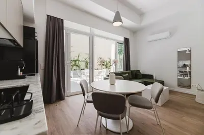 a living room with a table and chairs at Gran Turia Apartments in Valencia