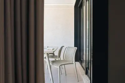 a table and chairs in a room with a window at White Beach Apartment in Valencia
