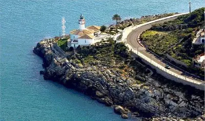 a lighthouse on an island in the water at Relax & Sea View & Beach Access in Faro de Cullera