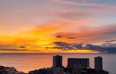 a sunset over a city with buildings and the ocean at 3 Bedroom Beautiful Home In Cullera in Cullera