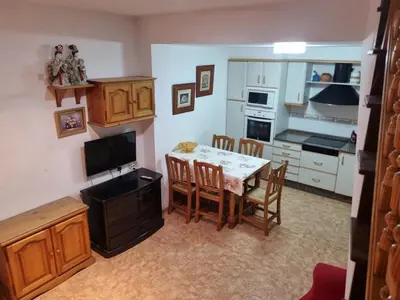 a kitchen with a table and chairs and a kitchen with at Casa Amando in Chulilla
