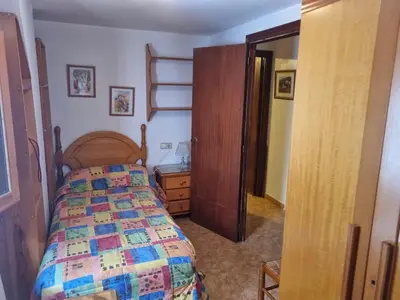 a bedroom with a bed and a wooden bed frame at Casa Amando in Chulilla