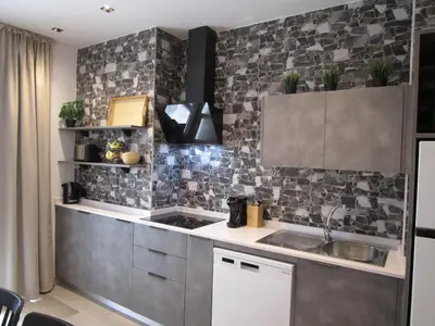 a kitchen with a sink and a tile wall at Travel Habitat Ruzafa Green House Terrace in Valencia