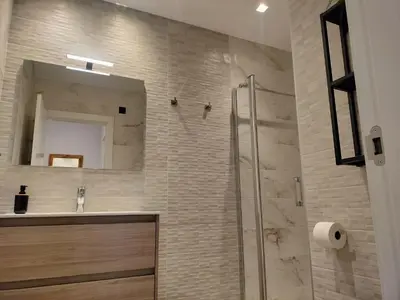 a bathroom with a sink and a shower with a mirror at Travel Habitat Ruzafa Green House Terrace in Valencia