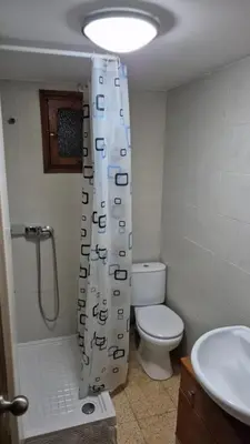 a bathroom with a toilet and a shower curtain at CANET de BERENGUER in Canet de Berenguer