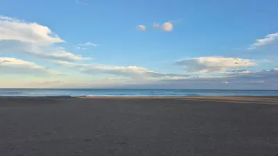a beach with a cloudy sky and the ocean at CANET de BERENGUER in Canet de Berenguer