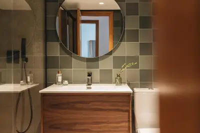 a bathroom with a sink and a mirror and a toilet at Seaview Flat Patacona in Valencia