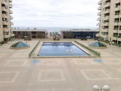 a large swimming pool in the middle of a building at Seaview Flat Patacona in Valencia