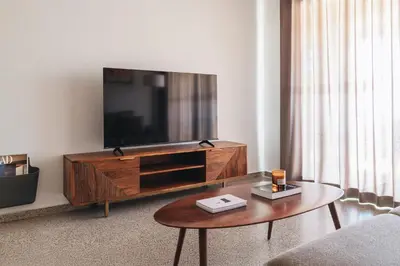 a living room with a television and a coffee table at Seaview Flat Patacona in Valencia