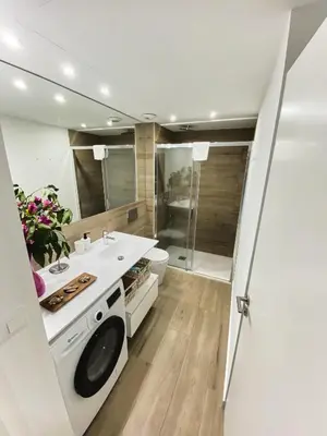 a bathroom with a sink and a washing machine at Central Market Deluxe Apartments in Valencia