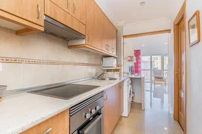 a kitchen with a sink and a stove top oven at Apto Playa Puebla de Farnals cerca de Valencia in Puebla de Farnals