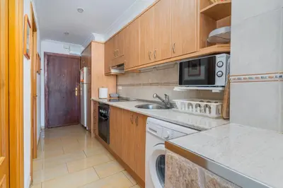a kitchen with a sink and a dishwasher at Apto Playa Puebla de Farnals cerca de Valencia in Puebla de Farnals