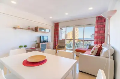 a living room with a white table and chairs at Apto Playa Puebla de Farnals cerca de Valencia in Puebla de Farnals