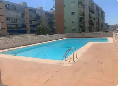 a large swimming pool in an apartment building at Confortable apto en la playa a 10min de Valencia in Valencia