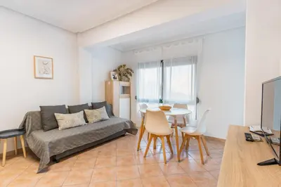 a living room with a couch and a table at Confortable apto en la playa a 10min de Valencia in Valencia
