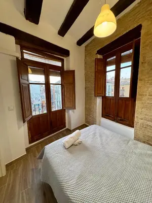 a dining room with a table and chairs and a window at Piso 2 - Apartamento Mercado Central in Valencia