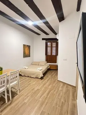 a dining room with a wooden table and chairs at Piso 2 - Apartamento Mercado Central in Valencia