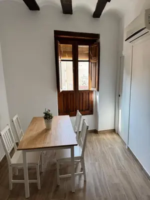 a dining room with a table and chairs and a window at Piso 3 - Apartamento Mercado Central in Valencia