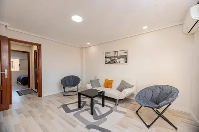 a living room with a couch and two chairs at Apartamento en el Cabanyal enfrente de la Marina Real in Valencia