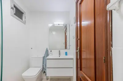 a bathroom with a toilet and a sink at Apartamento en el Cabanyal enfrente de la Marina Real in Valencia