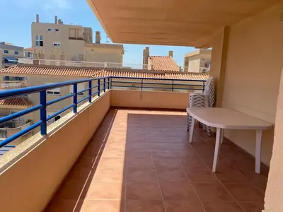 a balcony with a table and chairs on a building at Casa Ivan in Tavernes de Valldigna