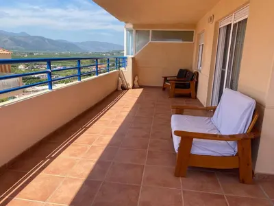a balcony with a chair and a view at Casa Ivan in Tavernes de Valldigna