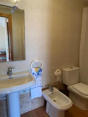 a bathroom with a sink and a toilet and a mirror at Casa Ivan in Tavernes de Valldigna