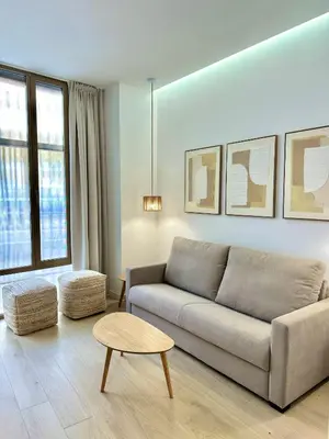 a living room with a couch and a table at Anelsa Suites Serranos 1 in Valencia