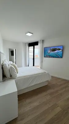 a white bedroom with a large bed and a large window at Apartamento Luxury in Valencia
