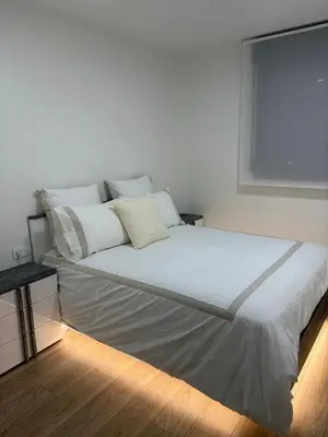 a bed with white sheets and pillows in a room at Apartamento Luxury in Valencia
