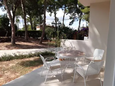 a table and chairs sitting on a patio at Casa Kiosko 2 bedroom chalet with swimming pool in La Eliana