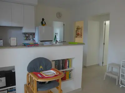 a kitchen with a counter and a table and a chair at Casa Kiosko 2 bedroom chalet with swimming pool in La Eliana