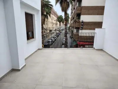 an empty sidewalk in front of a building with a gate at Mandarina Suites - Unique apartments in Valencia in Valencia
