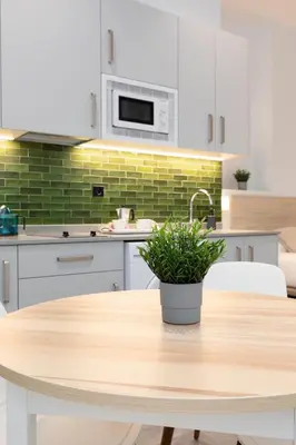 a kitchen with a wooden table with a potted plant on it at Apartamento 3º nuevo a estrenar cerca del mar in Valencia