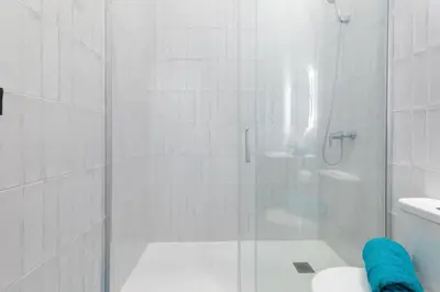 a white bathroom with a shower and a toilet at Apartamento 3º nuevo a estrenar cerca del mar in Valencia