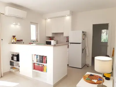 a kitchen with white cabinets and a white refrigerator at Casa Kiosko 3 bedroom chalet with swimming pool in La Eliana