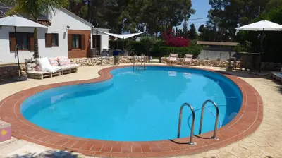 a large swimming pool with a red brick around it at Casa Kiosko 3 bedroom chalet with swimming pool in La Eliana