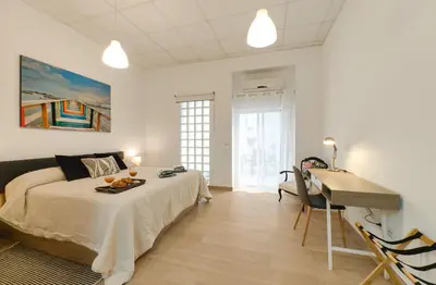 a bedroom with a bed and a desk in a room at Casa Montserrat in Valencia