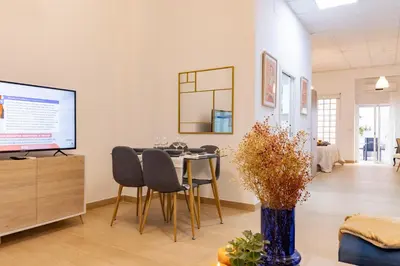 a dining room with a table and chairs and a tv at Casa Montserrat in Valencia
