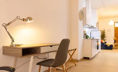 a desk with a lamp and a chair in a room at Casa Montserrat in Valencia