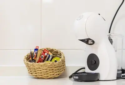 a basket of kitchen utensils on a counter next to a mixer at Casa Montserrat in Valencia