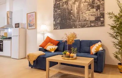 a living room with a blue couch and a table at Casa Montserrat in Valencia